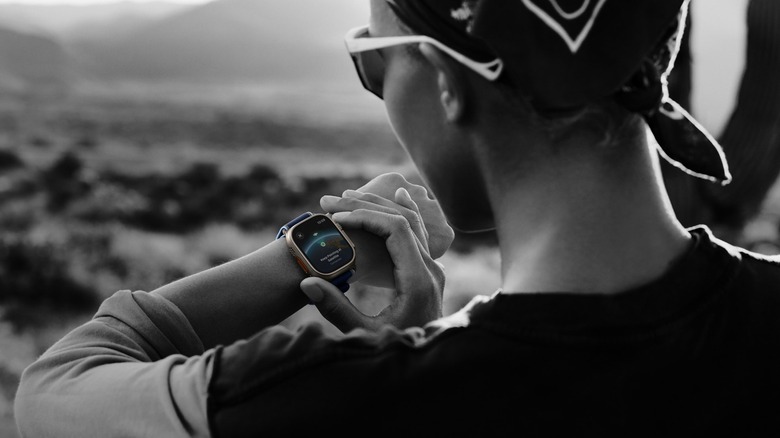 Person using Apple Watch Ultra 3 showing satellite communication