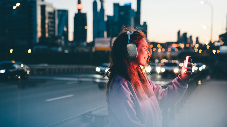 Person speaking into headphones outside
