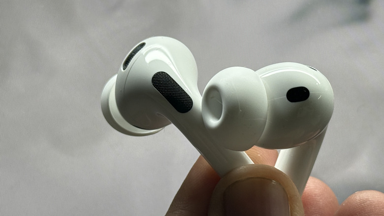 Person holding AirPods Pro 3.