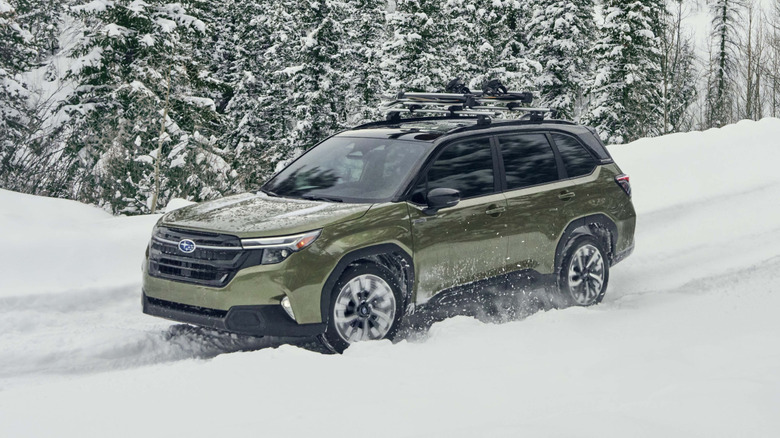 Olive Subaru Forester hybrid driving in snow.