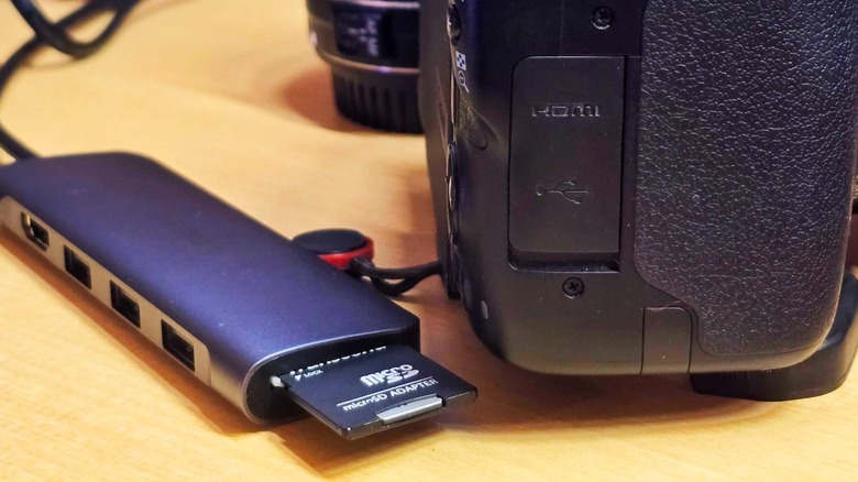 a USB hub with an SD card reader next to the author's camera