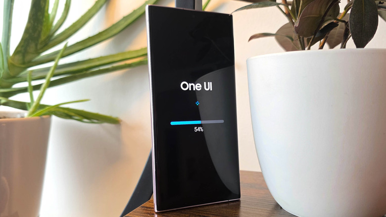 Samsung Galaxy S23 Ultra showing the update screen with potted plants surrounding it