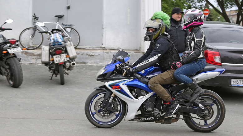 Motorcycle rider and passenger.
