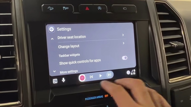 Man showing the Android Auto taskbar widgets in action
