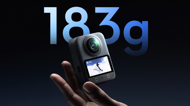 DJI Osmo 360 held in hand with its weight mentioned in text behind it