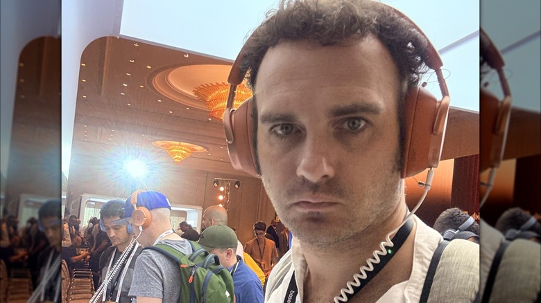 Man listening to Inspire XH1 at a crowded demo