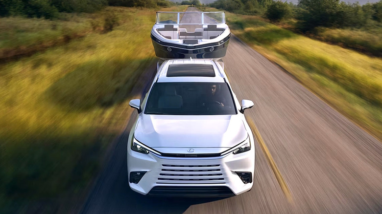 Person hauling a boat with a Lexus TX SUV