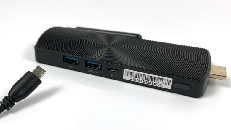Mini PC stick unplugged with power cord nearby