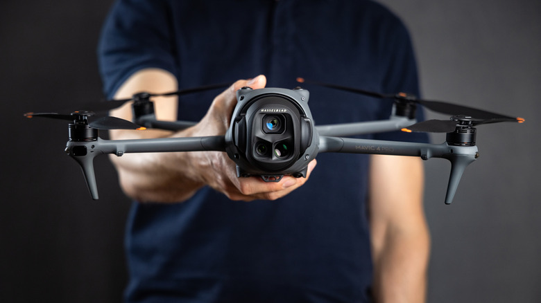 Person holding a DJI drone.