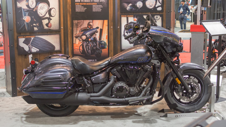 A V-Star 1300 motorbike from Yamaha on display on a podium during a vehicle show.