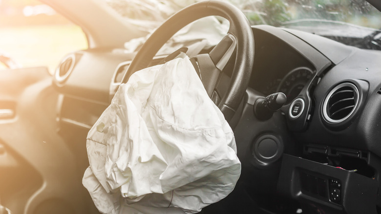 The interior of a vehicle after the driver's airbag deployed